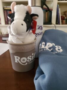 Grouping of Rosie's branched sweatshirt, water bottle, mug and stuffed cow